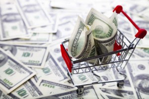 Shopping trolley with dollars. Sale.